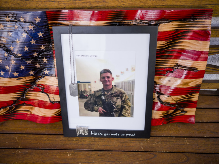 A framed photo of Austin Hawk on a bench outside the home of his mother, Julie Hawk, in Chino Hills, Calif., on June 4, 2021.