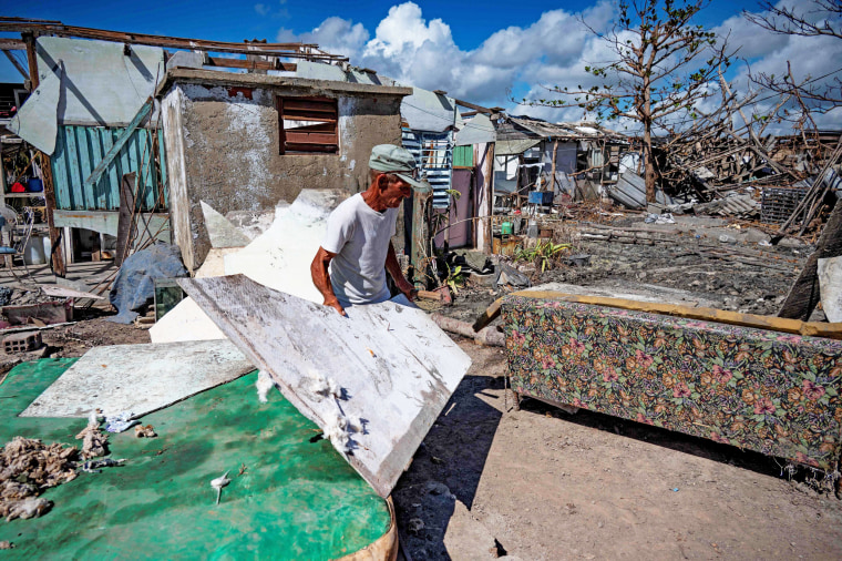 A man attempts to recover material damaged during Hurricane Ian in Cuba