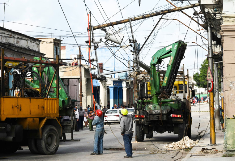 Workers of the Cuban electric company repair power lines in Cuba