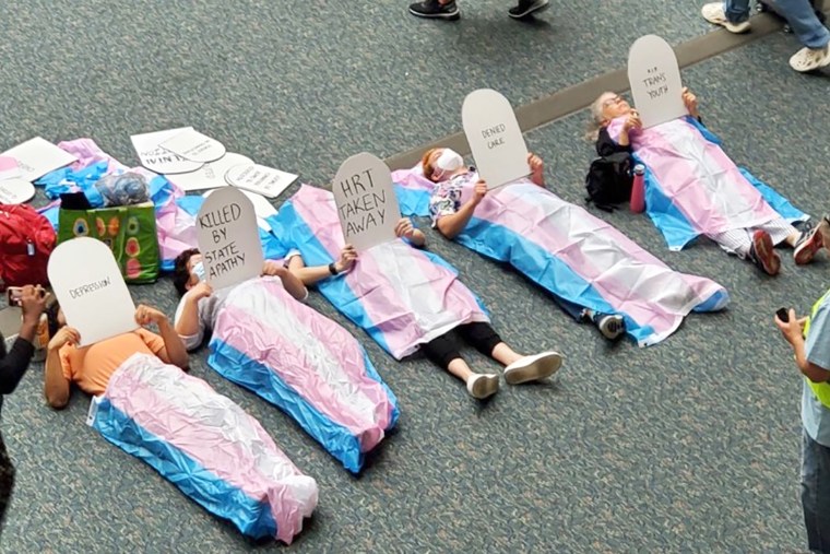 Protesting phase a "die" in the lobby of Orlando International Airport on October 28, 2022.