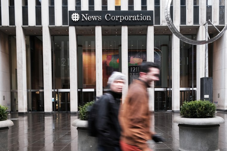 People walk the headquarters for News Corp