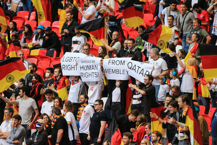 German fans with signs reading LGBTQ Rights Should Be Human Rights From Wembley To Qatar ahead of the UEFA Euro 2020 Championship Round of 16 match between England and Germany at Wembley Stadium on June 29, 2021 in London.