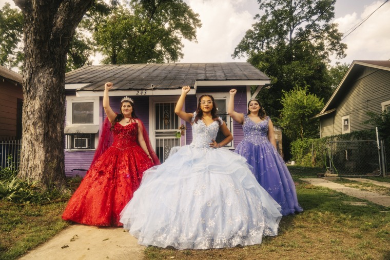 In their Quinceanera dresses, Poder Quince leaders Mirella Arianna Lupe Mena, Eulogia Rodriguez, and Victoria Silva raise their fists in a powerful show of solidarity.