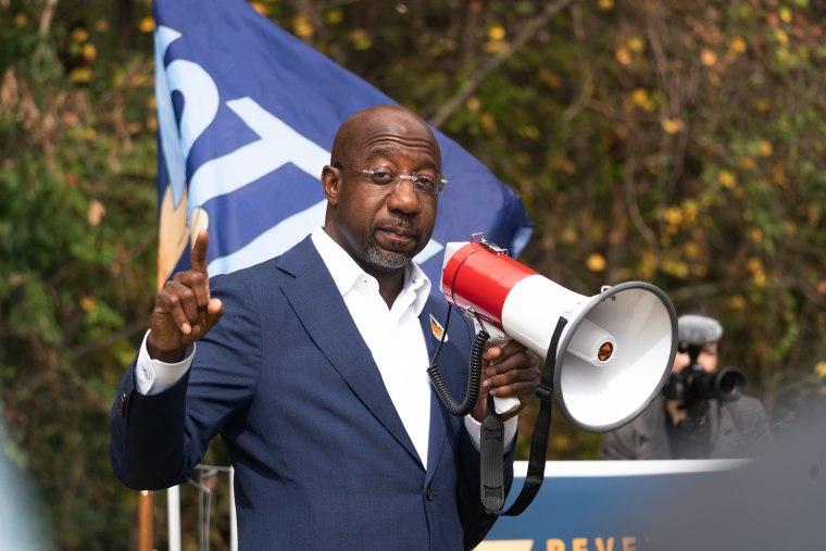 Sen. Raphael Warnock, D-Ga., meets with community members on the first day of early voting on Oct. 17, 2022 in Duluth.