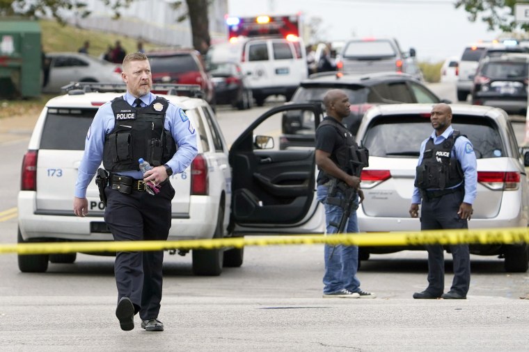 Law enforcement investigate the scene of a shooting at Central Visual and Performing Arts High School Monday, Oct. 24, 2022, in St. Louis. (AP Photo/Jeff Roberson)