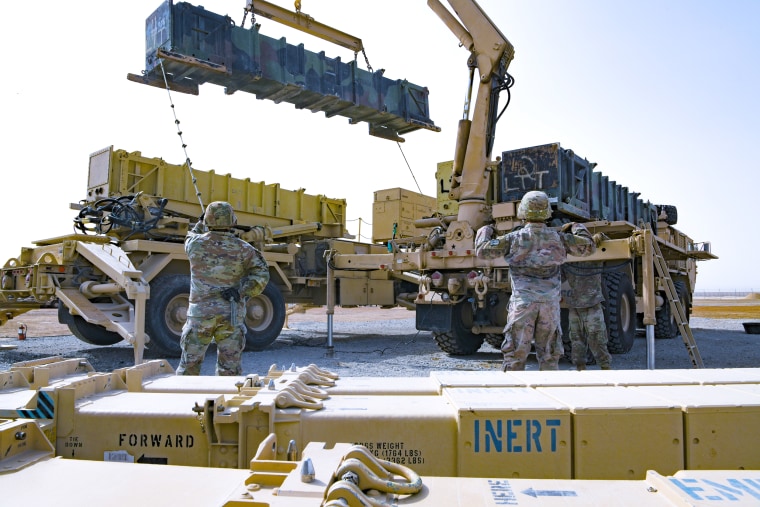 (From left) As Patriot missile reload crewmen, assigned to the 4th Battalion 3rd Air Defense Artillery Regiment, Pvt. Frank Gomez steadies a Guidance Enhanced Missile canister, while Spc. Michael Cook directs a soldier operating a guided missile transporter during a reload certification exercise July 28, 2022, at Al Dhafra Air Base, United Arab Emirates. Reload crews consist of five person teams, and are expected to safely move four missile segment enhancement canisters off, and four more back on within a one-hour time limit. (U.S. Air Force photo by Tech. Sgt. Jeffrey Grossi)