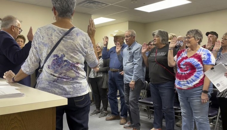 Nye County Clerk Mark Kampf, left, swears in a group of residents Wednesday who will hand count early ballots in Pahrump, Nev. 
