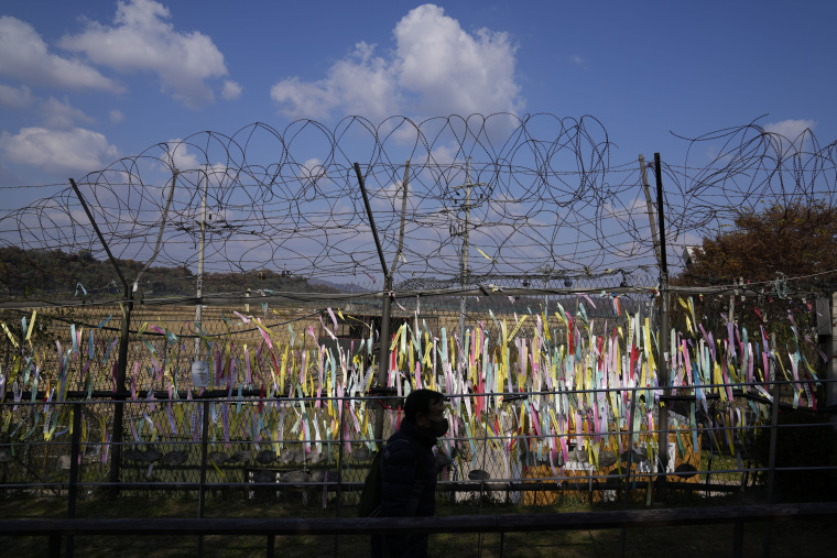 Ribbons with messages wishing for the reunification of the two Koreas hang on a fence in the border city of Paju, South Korea, on Friday.