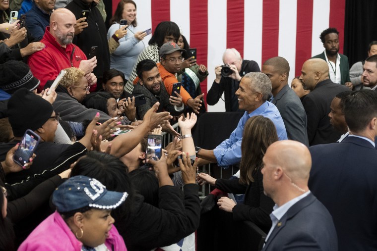 Former President Barack Obama at the crowd at Renaissance High School in Detroit on October 29, 2022, following a campaign rally for Michigan Democrats ahead of the midterm elections.