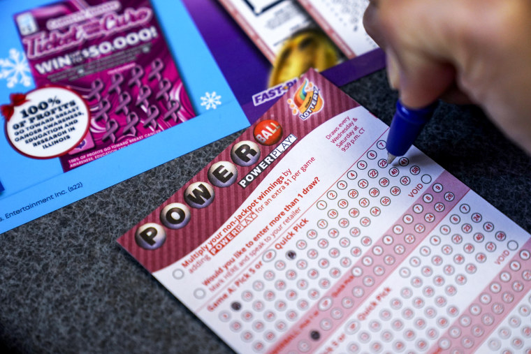 A customer fills out a Powerball lottery ticket at a convenience store in Northbrook, Ill., on Oct. 25, 2022.