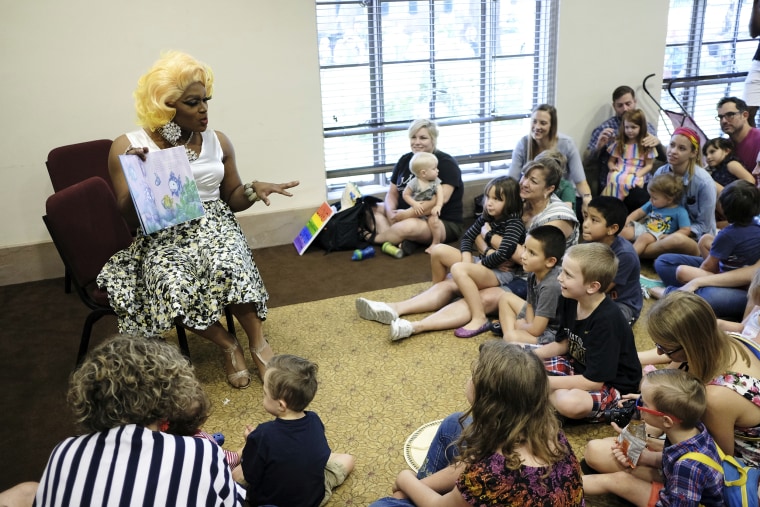 A drag performer by the name of Champagne Monroe reads the children's book "Rainbow Fish" to a group of kids and parents at the Mobile Public Library for Drag Queen Story Hour in Mobile, Ala. on Sept. 8, 2018. 
