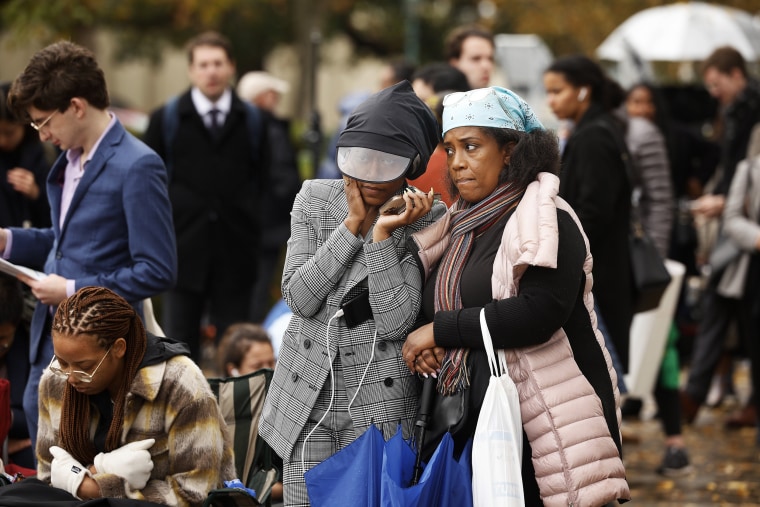 Taylor Dumpson and her mother Kimberly Dumpson listen to oral arguments outside the Supreme Court on Oct. 31, 2022.