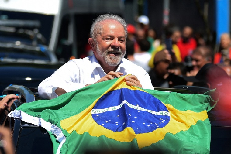 Brazilian former President (2003-2010) and candidate for the leftist Workers Party (PT) Luiz Inacio Lula da Silva holds a Brazilian flag while leaving a polling station during the presidential run-off election, in Sao Paulo, Brazil, on October 30, 2022. - After a bitterly divisive campaign and inconclusive first-round vote, Brazil elects its next president in a cliffhanger runoff between far-right incumbent Jair Bolsonaro and veteran leftist Luiz Inacio Lula da Silva. (Photo by CARL DE SOUZA / AFP) (Photo by CARL DE SOUZA/AFP via Getty Images)