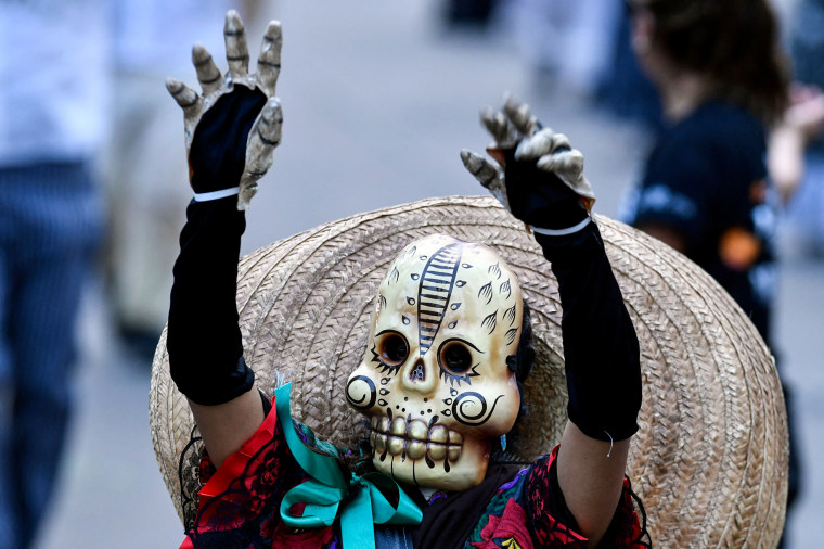 People take part in the "Day of the Dead Parade" in Mexico City on Oct. 29, 2022.