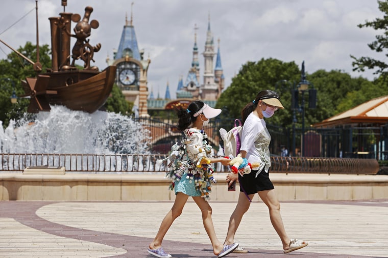 Tourists visit Shanghai Disney Resort, in China, on June 30, 2022. 