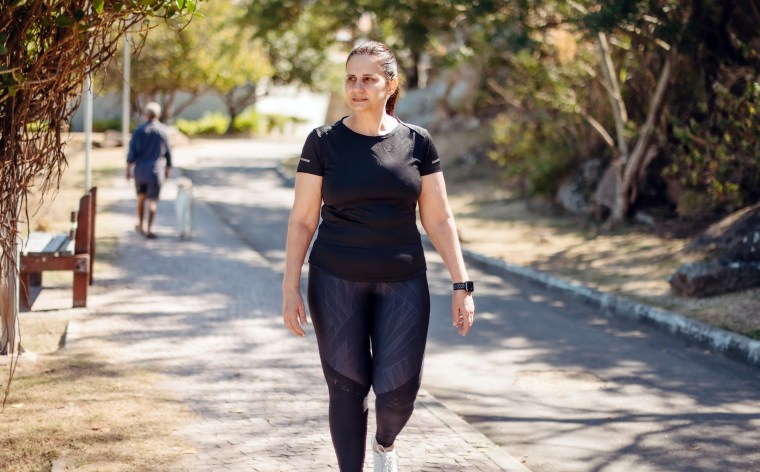 mature woman walking for wellness outdoors