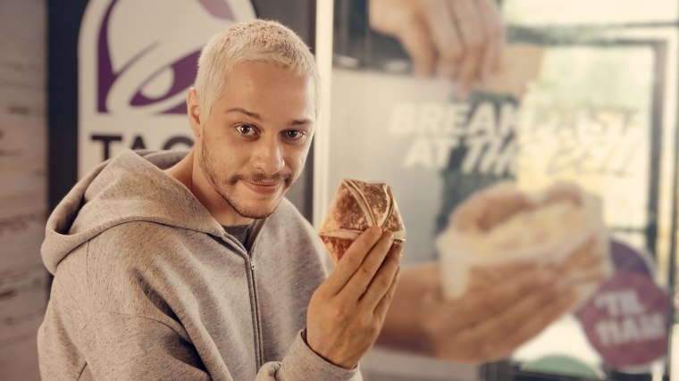 Pete Davidson with breakfast crunch wrap from Taco Bell