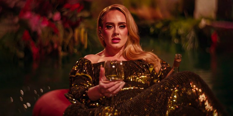 Adele floats on a river while drinking wine in the video for "I Drink Wine."