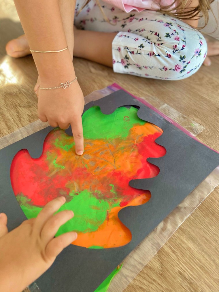 child's art project with leaves