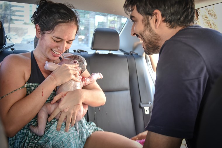 Dr. Gabriela Correia and her husband, Gilberto Godoy, are pictured here meeting their son.