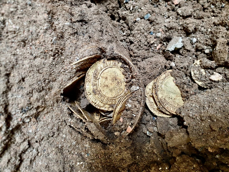 The coins as they were found in the dirt.