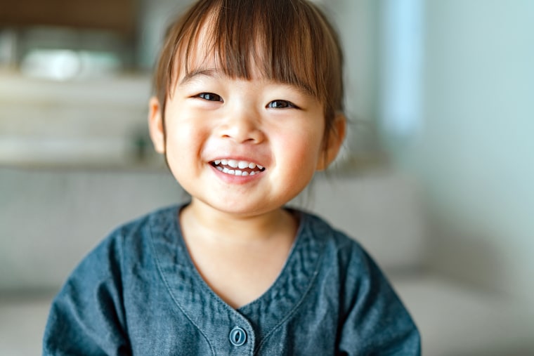 Portrait of small girl in living room at home