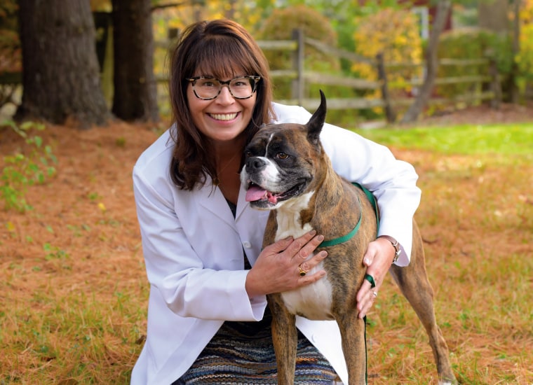 Dr. Renee Alsarraf poses with her dog, Dusty. The veterinarian is doing well four years after undergoing treatment for endometrial cancer.