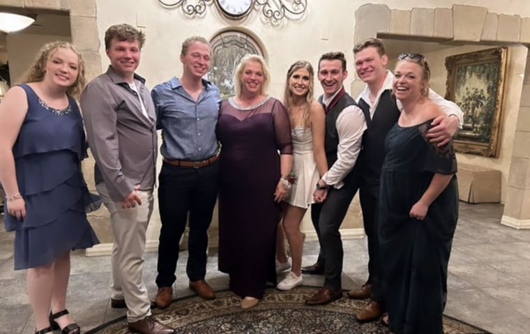 The whole gang's here! Janelle Brown and her six children pose for a photo at Logan's wedding.