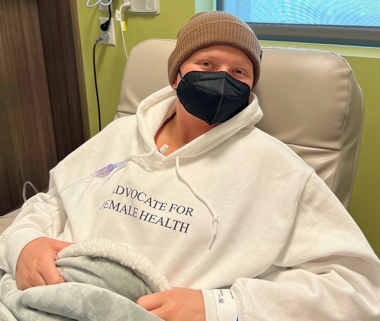 Jessie Sanders in the infusion center wearing her jacket to spread awareness on her last chemotherapy session.