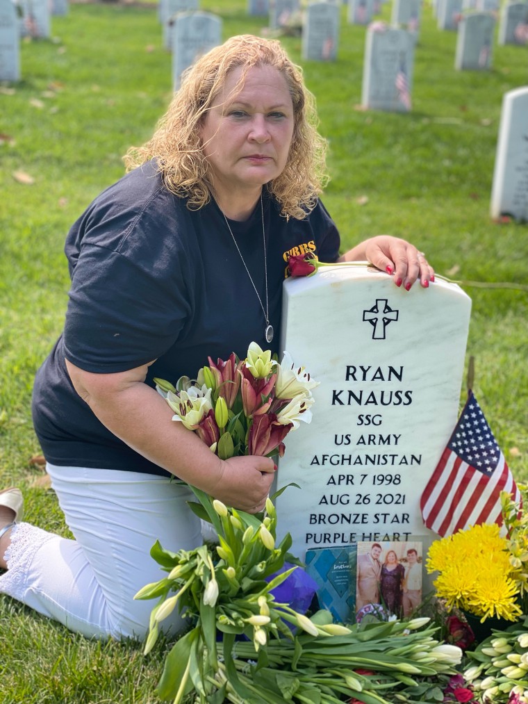 Knauss Selph sits at the grave of her son, Ryan, at Arlington National Cemetery.