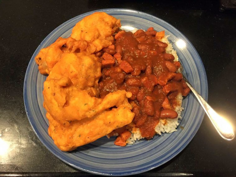 A plate of red beans and rice and fried cod.