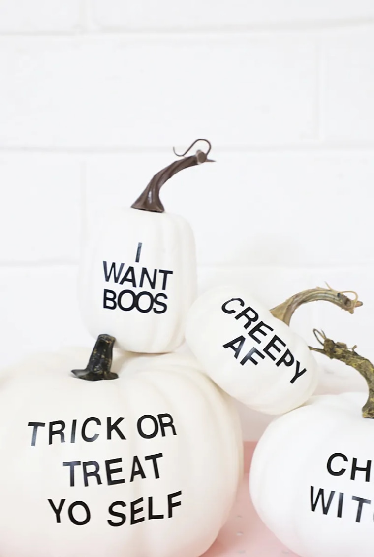 white pumpkin with black punny typography