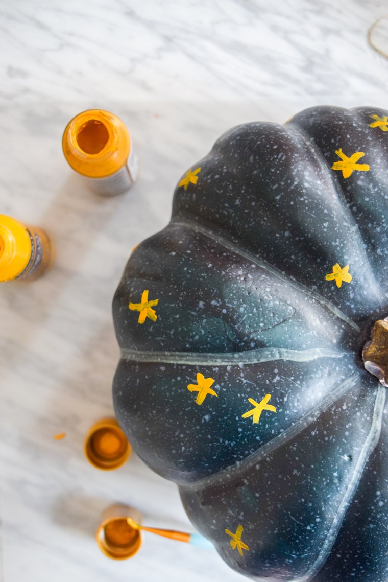 black pumpkin with yellow and gold stars