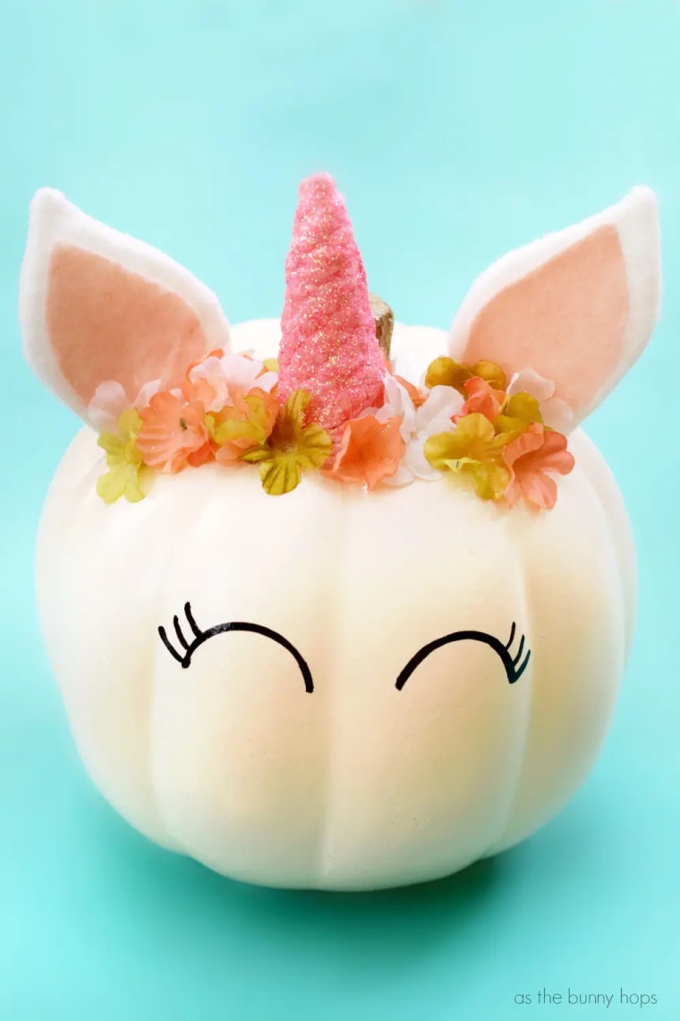 cream pumpkin decorated to look like a unicorn