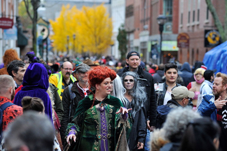 Revellers walk through the streets during Halloween on in Salem, MA.