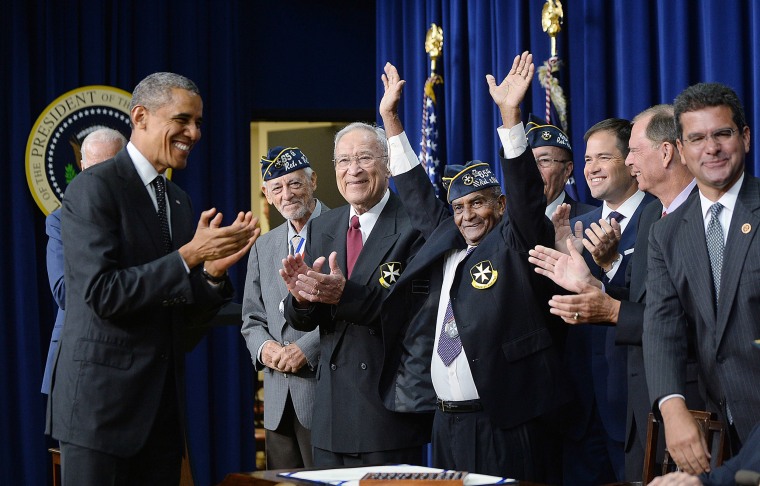 President Barack Obama with members of the 65th Infantry Regiment, known as the Borinqueneers, 