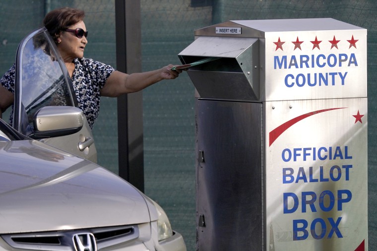 A voter casts their ballot at a secure ballot drop box at the Maricopa County Tabulation and Election Center in Phoenix, on Nov. 1, 2022.