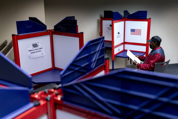 Image: A voter fills out an early voting ballot in Alexandria, Va., on Sept. 26, 2022.