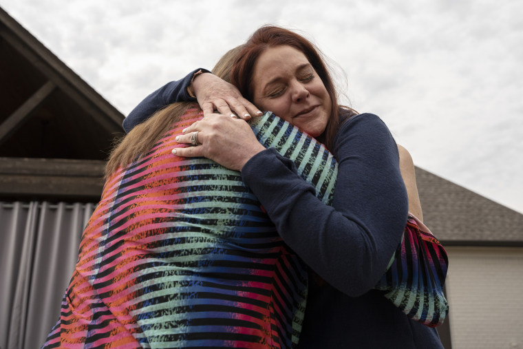 Misti Gossett hugs her sister, Angie Marchese, at her home in Hernando, Miss., on Nov. 1, 2022.