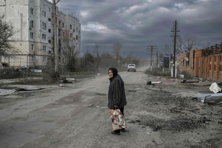A woman walks across a road in Kherson, on Nov. 3, 2022.
