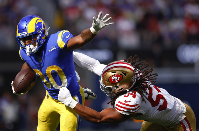 Ronnie Rivers of the Los Angeles Rams is tackled by Fred Warner  of the San Francisco 49ers.
