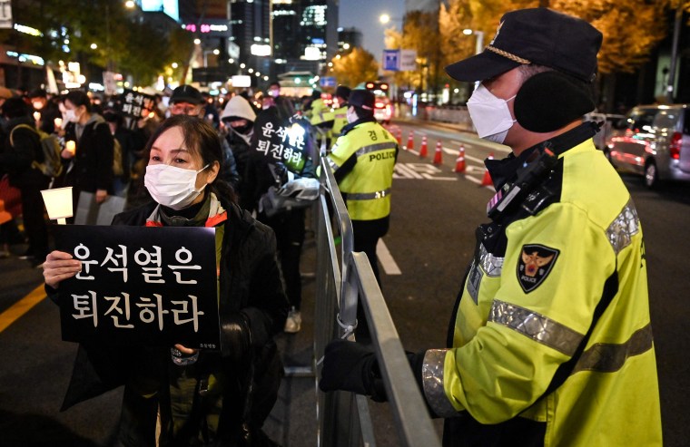 People take part in a candlelight vigil to commemorate the 156 people killed in the October 29 Halloween crowd crush in Seoul on Nov. 5, 2022.