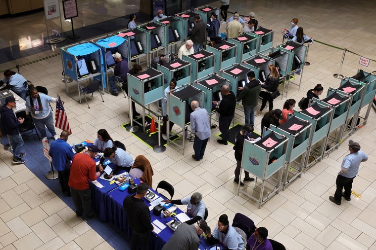 Clark County Election Department poll workers check people in at the Meadows Mall on Nov. 8, 2022 in Las Vegas. 