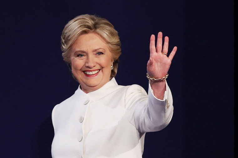 Hillary Clinton waves to the crowd from the stage during a debate.