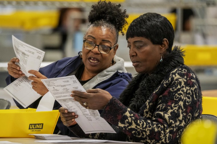 Election workers prepare ballots to be scanned at the Philadelphia Ballot Processing Center on Nov. 8, 2022. 