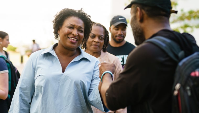Image: Democratic gubernatorial candidate Stacey Abrams fist bumps a well-wisher on a visit to Georgia State University.