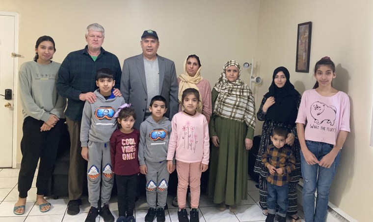 David Tyson with Mohammed Faqir Jawzjani and his family at their home in New Jersey