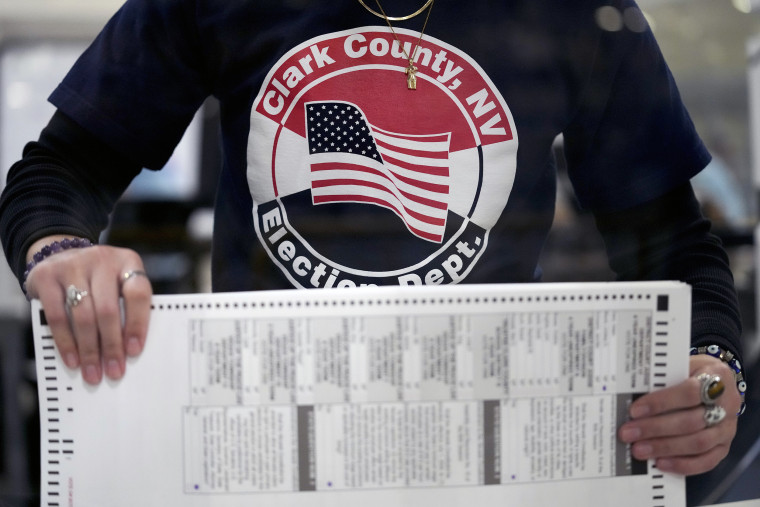 An election worker tabulates mail-in ballots at the Clark County Election Department in Las Vegas on Nov. 9, 2022.