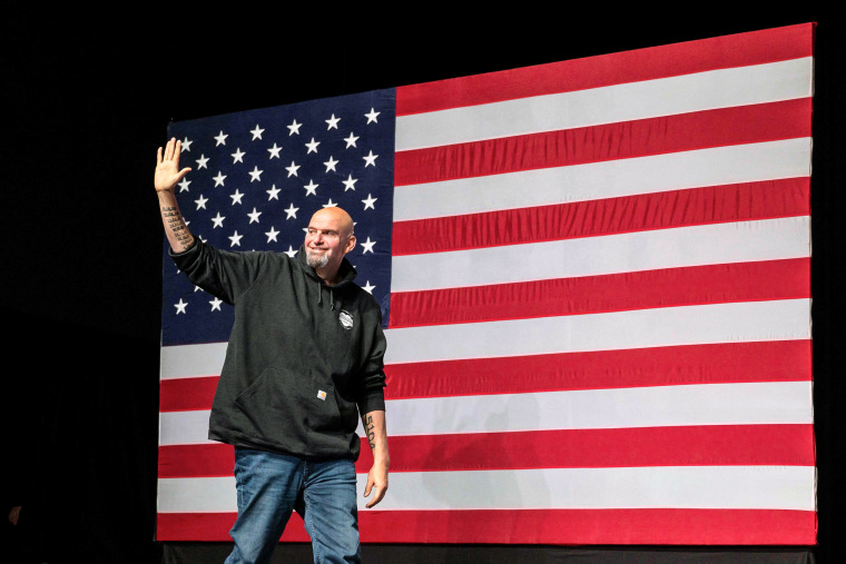 Image: Pennsylvania Democratic Senatorial candidate John Fetterman waves as he arrives onstage at a watch party during the midterm elections at Stage AE in Pittsburgh, Pa., on Nov. 8, 2022.
