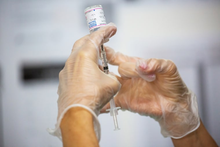 A healthcare worker prepares a dose of the Moderna Covid-19 vaccine